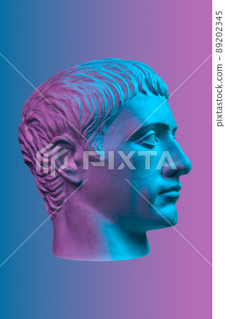 Blue purple gypsum copy of ancient statue of Germanicus Julius Caesar head for artists isolated on color background. Renaissance epoch. Plaster sculpture of man face. Template for art design 89202345