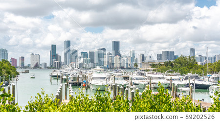 Miami Downtown skyline in daytime with Biscayne Bay and yachts 89202526