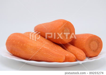 Peeled fresh carrots on a white plate, proper nutrition, vitamins. Peeled fresh carrots on a white plate, proper nutrition, vitamins. 89203274