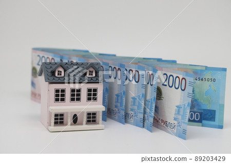 toy house on banknotes, buying your own home, mortgage, symbol of material well being. 89203429