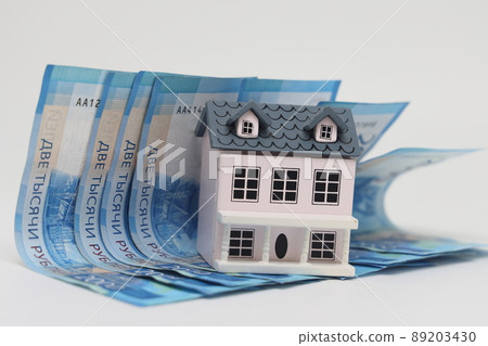 toy house on banknotes, buying your own home, mortgage, symbol of material well being. 89203430