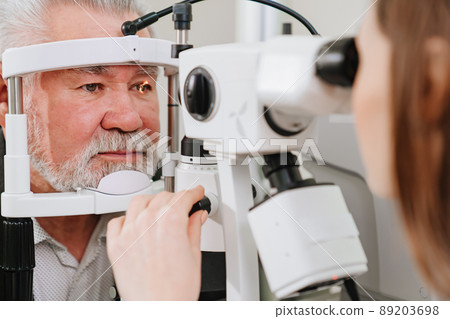 ophthalmologist examination of elderly man with slit lamp. medical equipment 89203698