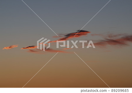 Early morning clouds dyed red in the morning sun Early morning clouds dyed red in the morning sun 89209685
