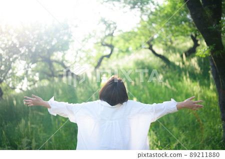 A person who takes a deep breath in the fresh green without a face 89211880