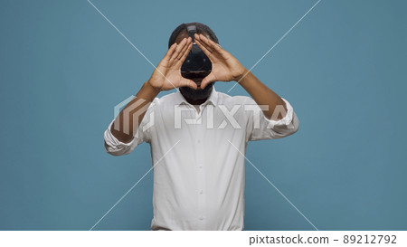 Modern person playing with electronic virtual reality headset, enjoying futuristic 3d technology. Young man using vr glasses to work with innovative cyberspace simulation, interactive goggles. 89212792