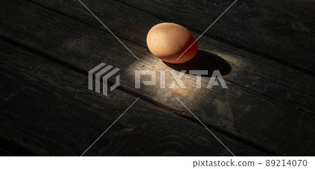 Chicken egg on a wooden background. Concept Chicken egg on a wooden background. Concept 89214070