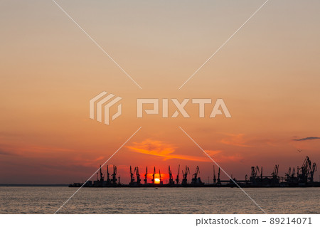 Summer orange sunset of the Sea of Azov against the backdrop of the Berdyansk port. 89214071