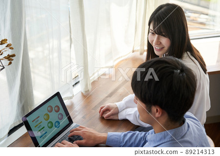 Young couple looking at a laptop 89214313