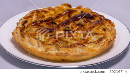 Handmade apple pie on a white plate (horizontally long) Handmade apple pie on a white plate (horizontally long) 89216744
