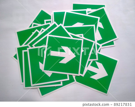 Fire exit sign or Sign fire escape. Pile of evacuation arrow stickers. White symbol on green background. Emergency arrow warning for safety to run exit of building. Fire exit sign or Sign fire escape. Pile of evacuation arrow stickers. White symbol on green background. Emergency arrow warning for safety to run exit of building. 89217831