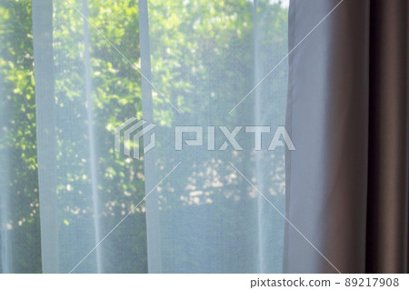 Close up curtain window with green garden background 89217908