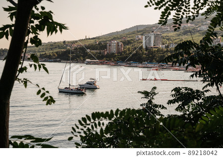 white motor and sailing yachts stand in a bay on the sea white motor and sailing yachts stand in a bay on the sea 89218042