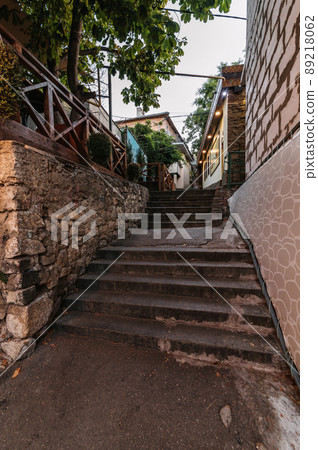beautiful narrow alley with stone trim and facades of buildings beautiful narrow alley with stone trim and facades of buildings 89218062