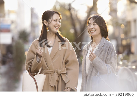 A woman in a coat doing wind shopping A woman in a coat doing wind shopping 89219060