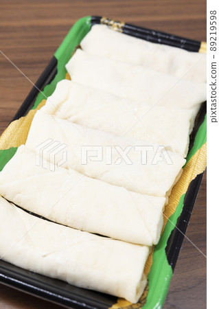 Raw spring rolls before baking Raw spring rolls before baking 89219598