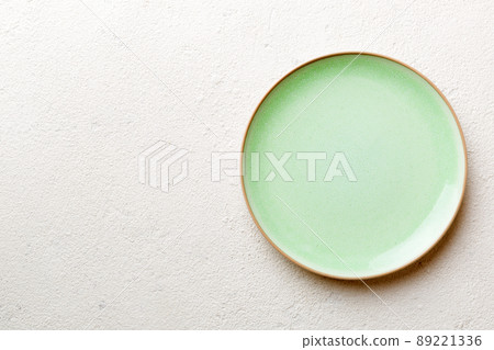Top view of empty green plate on cement background. Empty space for your design Top view of empty green plate on cement background. Empty space for your design 89221336