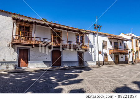 Teror at Gran Canaria, Spain. A beautiful traditional town with colorful houses with wooden balconies Teror at Gran Canaria, Spain. A beautiful traditional town with colorful houses with wooden balconies 89221857