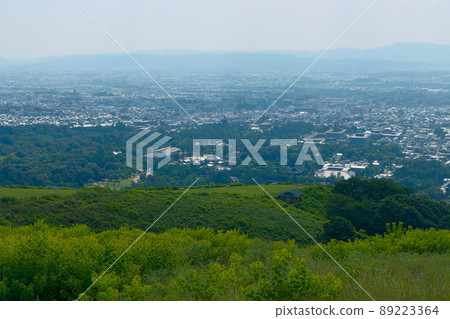 Looking at the lower world from the second step at Mt. Wakakusa in midsummer-the first step from the grass at your feet and the city of Nara Looking at the lower world from the second step at Mt. Wakakusa in midsummer-the first step from the grass at your feet and the city of Nara 89223364