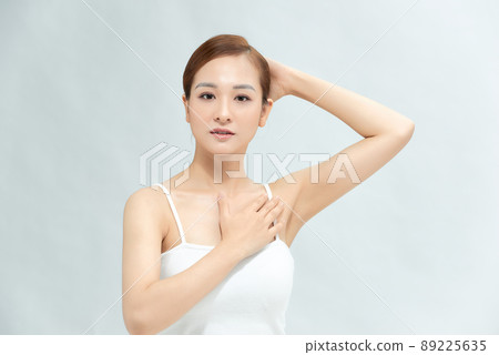Close-up of a beautiful young woman showing her smooth armpit isolated on white background Close-up of a beautiful young woman showing her smooth armpit isolated on white background 89225635