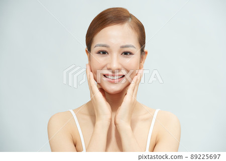 Youthful Vietnamese girl smiling and looking at camera 89225697