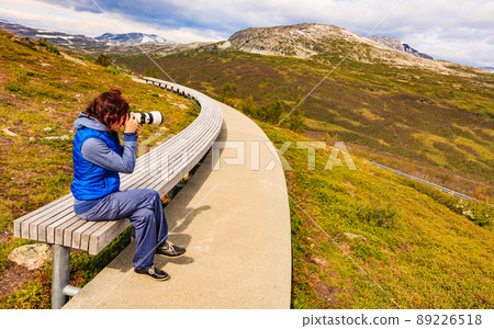 Woman on Vedahaugane rest stop, Norway Woman on Vedahaugane rest stop, Norway 89226518