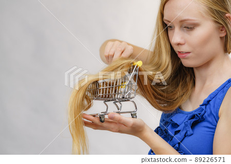 Girl with her long hair in shopping cart Girl with her long hair in shopping cart 89226571