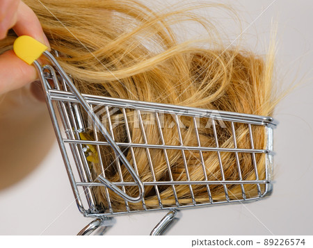 Girl with her long hair in shopping cart 89226574