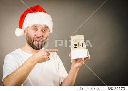 December 24th. Man santa hat holds calender 89226575