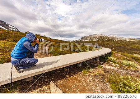 Woman on Vedahaugane rest stop, Norway 89226576