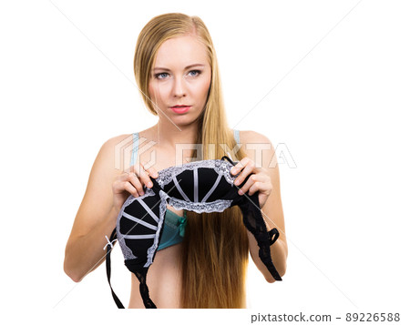 Woman trying on black bra with lace 89226588