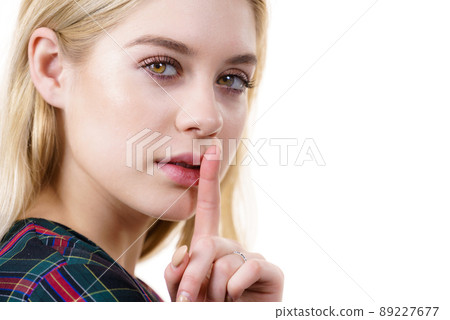 Woman showing silence gesture 89227677