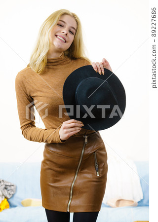 Woman wearing suede and black hat Woman wearing suede and black hat 89227686