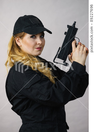 Woman holds gun in hands. Woman holds gun in hands. 89227696