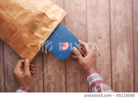 a lunch box in paper packet on table a lunch box in paper packet on table 89228086