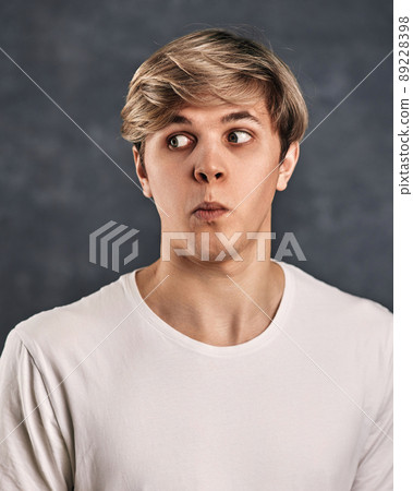 Young caucasian confused man on gray background. 89228398
