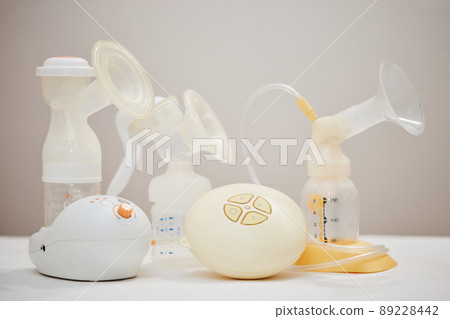 different breast pumps on table. Maternity and child care. different breast pumps on table. Maternity and child care. 89228442