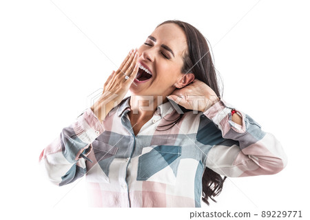Sleepy and tired woman yawns with mouth wide open and a hand in front of her mouth. Sleepy and tired woman yawns with mouth wide open and a hand in front of her mouth. 89229771