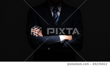 Businessman middle man with arms folded 89230822