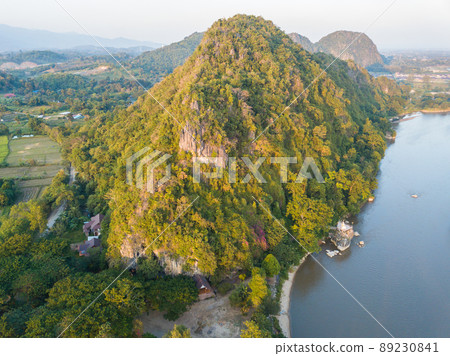 The high angle view of mountains and Kok river nearly Chiang Rai beach a river bank with rocky shores view. The high angle view of mountains and Kok river nearly Chiang Rai beach a river bank with rocky shores view. 89230841