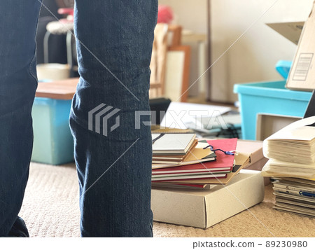 The feet of jeans of a person who is organizing his parents' house The feet of jeans of a person who is organizing his parents' house 89230980