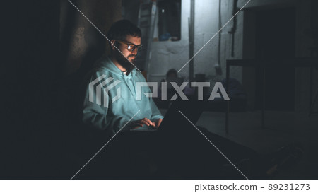 Programmer working in dark bomb shelter 89231273