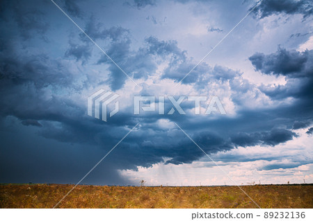 Sky During Rain Horizon Above Rural Wheat Landscape Field. Agricultural And Weather Forecast Concept. Storm, Thunder, thunderstorm, stormclouds, , , . Rainy Day, stormclouds Sky During Rain Horizon. Sky During Rain Horizon Above Rural Wheat Landscape Field. Agricultural And Weather Forecast Concept. Storm, Thunder, thunderstorm, stormclouds, , , . Rainy Day, stormclouds Sky During Rain Horizon. 89232136
