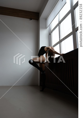 Sensual topless lady standing near window at home 89232158