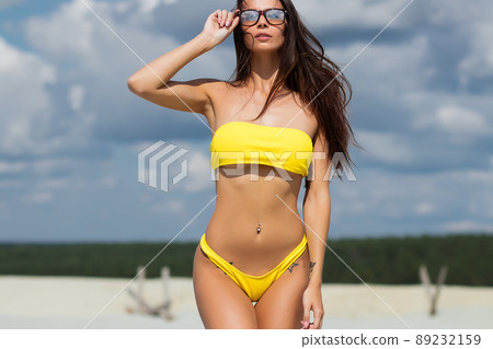 Beautiful woman in swimsuit on beach Beautiful woman in swimsuit on beach 89232159