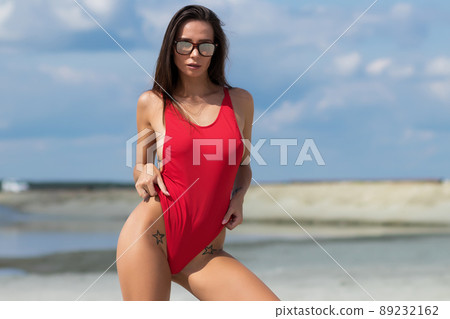 Beautiful woman in swimsuit on beach Beautiful woman in swimsuit on beach 89232162