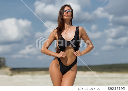 Beautiful woman in swimsuit on beach Beautiful woman in swimsuit on beach 89232195