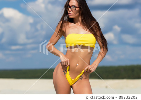 Beautiful woman in swimsuit on beach Beautiful woman in swimsuit on beach 89232202