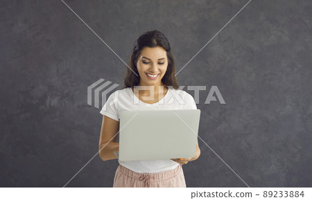 Smiling woman use laptop work online on device 89233884
