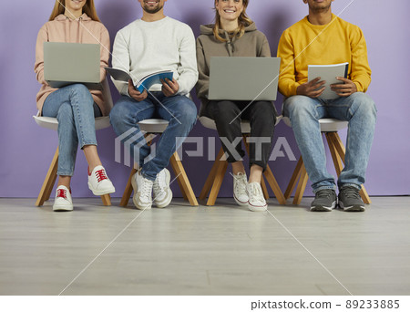 Young people use laptops and notebooks to prepare for lectures, exams and interviews. Young people use laptops and notebooks to prepare for lectures, exams and interviews. 89233885