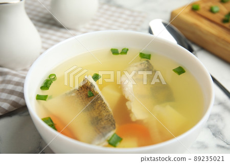 Delicious fish soup in bowl on table, closeup Delicious fish soup in bowl on table, closeup 89235021
